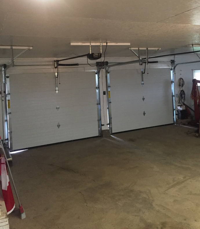 Insulated garage with double doors, concrete floor and automatic openers