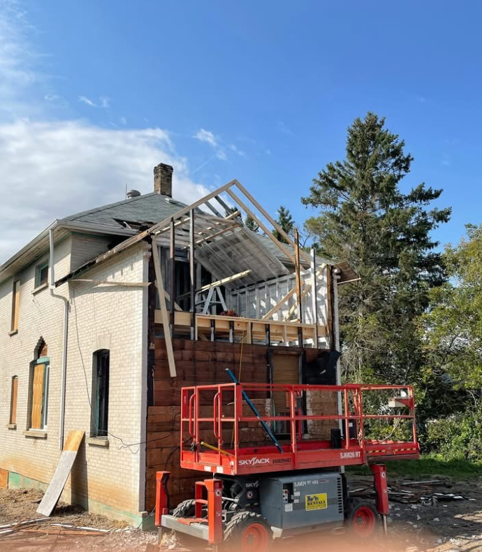 Renovations, exterior 1912 two storey house. First phase of renovation (some new walls and rafters up on 2nd storey)